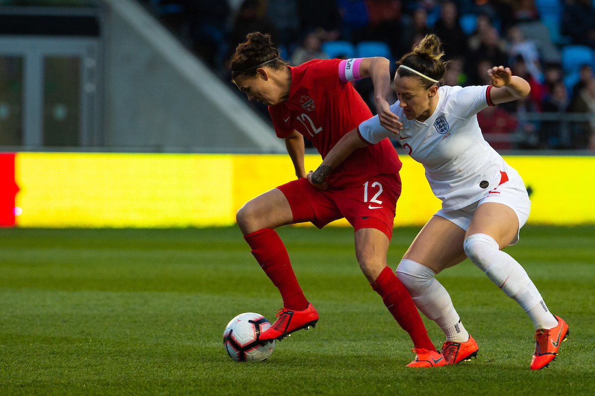 Lucy Bronze of England Women is held off by Christine Sinclair of Canada Women during the International Friendly match at City Football Academy, Manchester Picture by Matt Wilkinson/Focus Images Ltd 07814 960751 05/04/2019